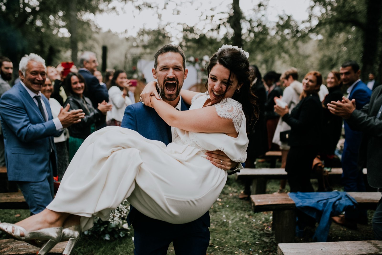 Wedding guests celebrating during an outdoor destination wedding in France.