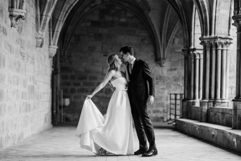 Bride and groom in a French château cloister during their destination wedding in France.