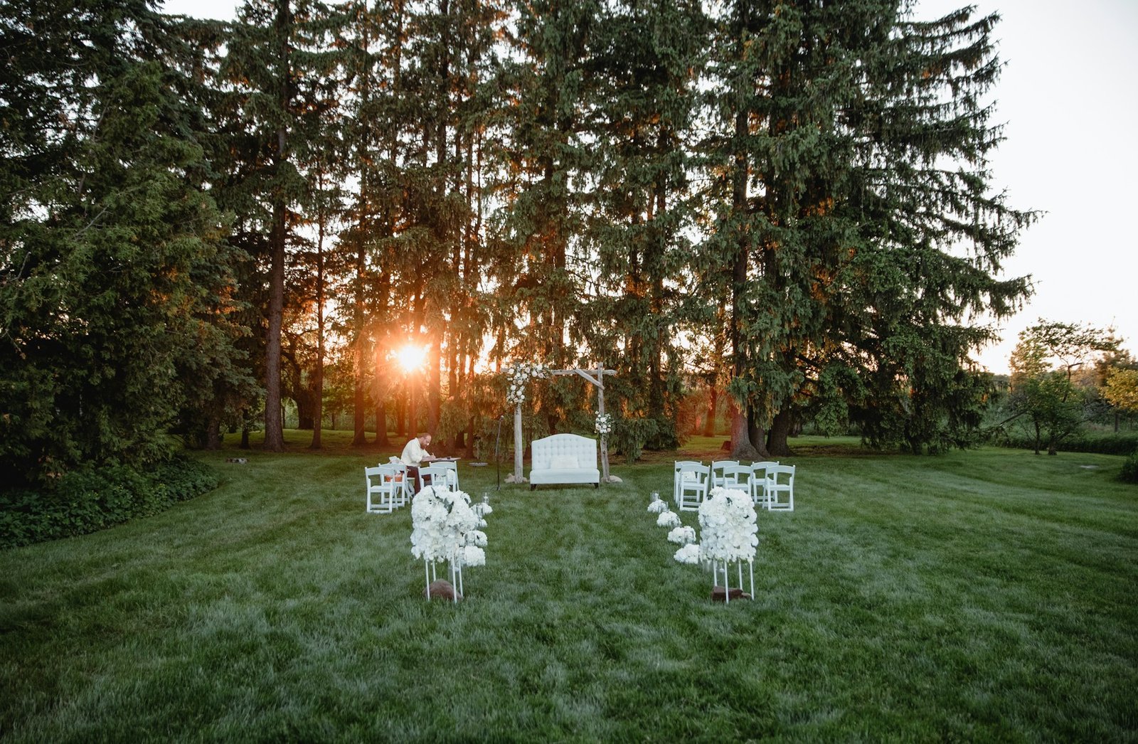 Cérémonie de mariage intime dans un jardin avec quelques proches autour du couple.